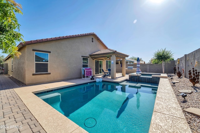 view of pool with an in ground hot tub and a patio