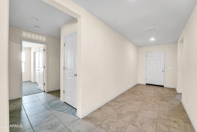 corridor with light tile patterned floors