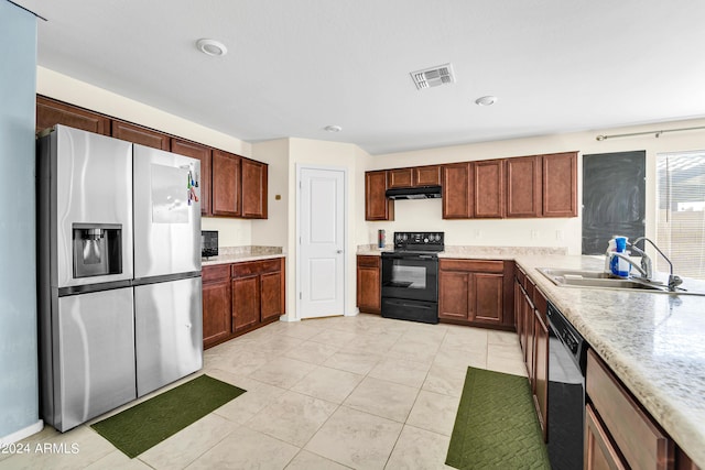 kitchen with sink, black appliances, and light tile patterned flooring