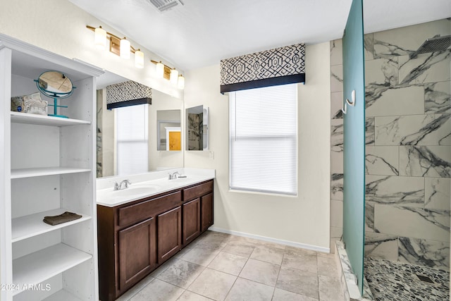 bathroom featuring vanity and tiled shower