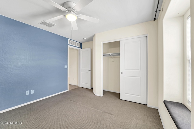 unfurnished bedroom featuring carpet flooring, ceiling fan, and a closet