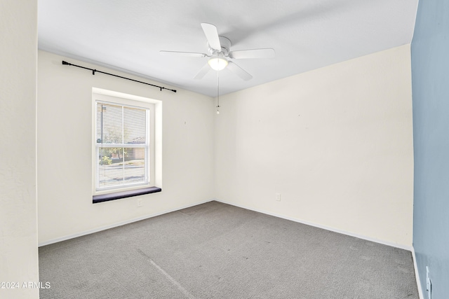 carpeted spare room with ceiling fan