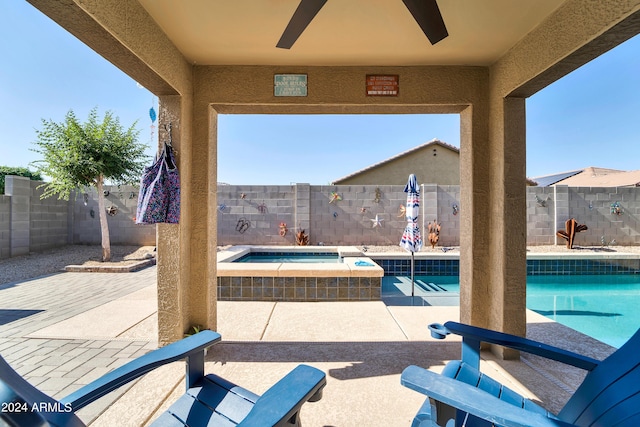 view of patio / terrace featuring ceiling fan and a pool with hot tub