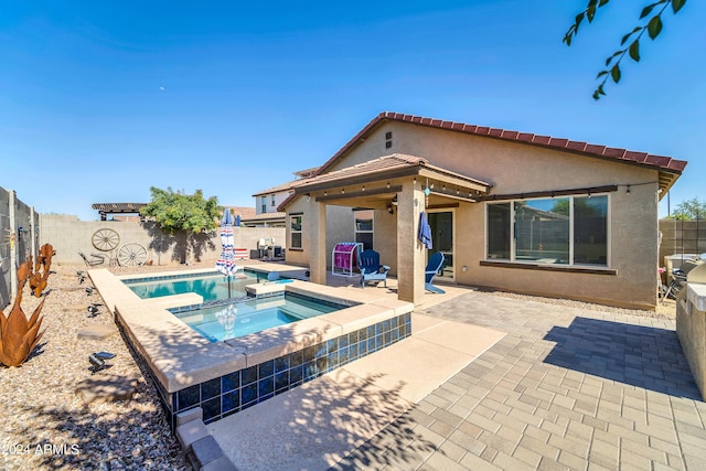 view of pool featuring an in ground hot tub and a patio area