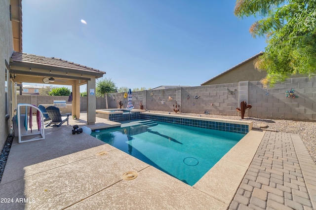 view of swimming pool featuring an in ground hot tub, ceiling fan, and a patio area