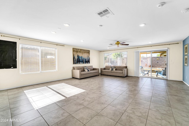 unfurnished living room featuring light tile patterned flooring and ceiling fan