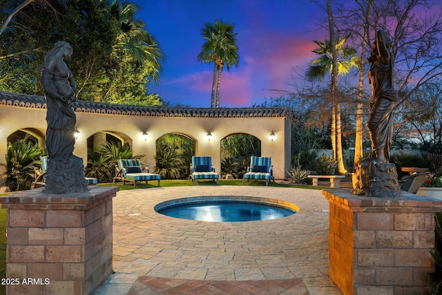 view of pool with a patio and an in ground hot tub