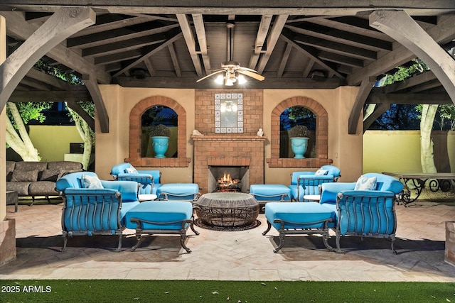 view of patio with a gazebo and an outdoor living space with a fireplace