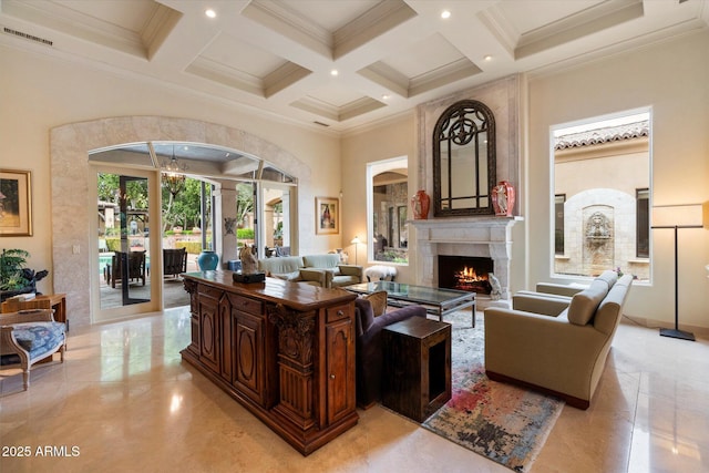 living room with visible vents, coffered ceiling, a warm lit fireplace, and a towering ceiling