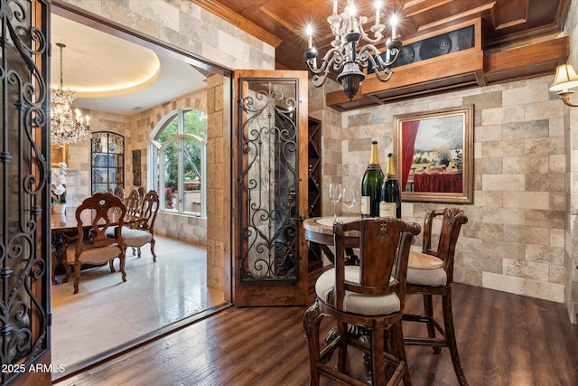 dining area with a chandelier and wood finished floors