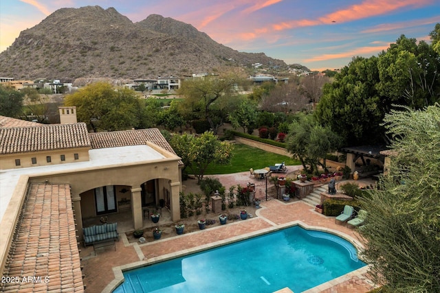 pool with a mountain view and a patio