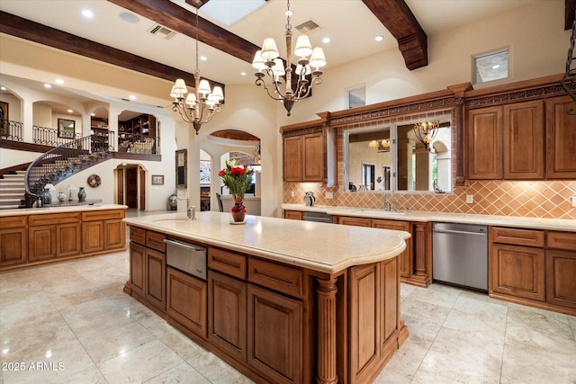 kitchen featuring stainless steel dishwasher, a warming drawer, arched walkways, and visible vents