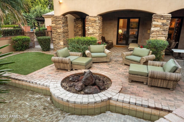 view of patio / terrace featuring an outdoor living space with a fire pit and fence