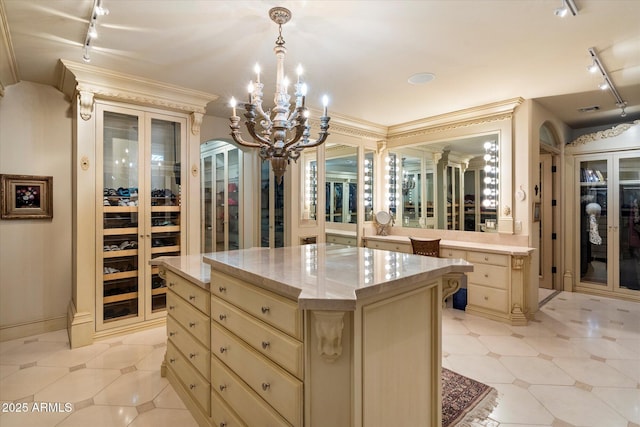 walk in closet with an inviting chandelier