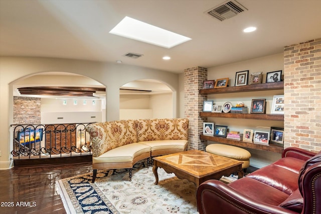 living area featuring a skylight, recessed lighting, and visible vents