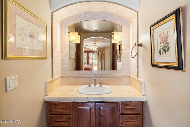 ensuite bathroom with ensuite bath, backsplash, vanity, and a ceiling fan