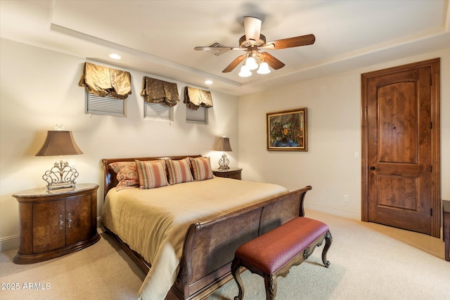 bedroom featuring a ceiling fan, baseboards, recessed lighting, a raised ceiling, and light colored carpet