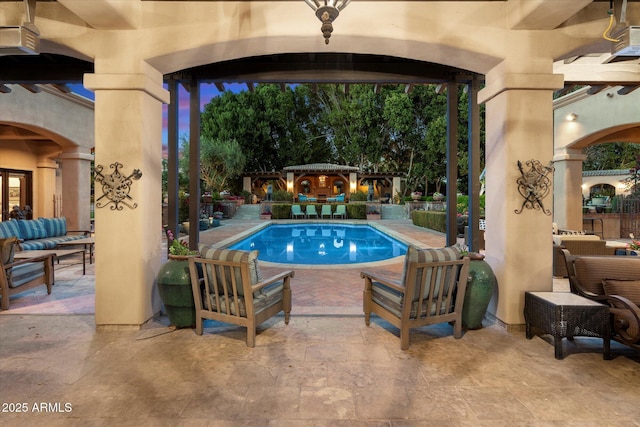 pool with a patio and an outdoor living space