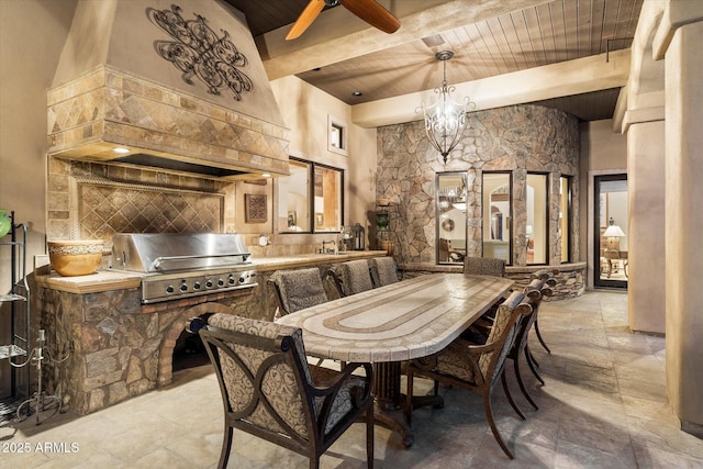 dining area with beam ceiling, wood ceiling, ceiling fan, and stone tile flooring