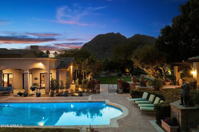 outdoor pool with a patio and ceiling fan