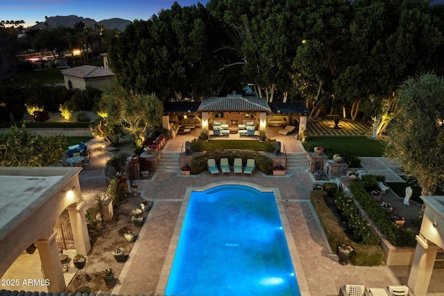 pool featuring a gazebo, an outdoor living space, and a patio