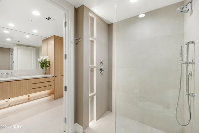 full bath with vanity, a tile shower, visible vents, and recessed lighting