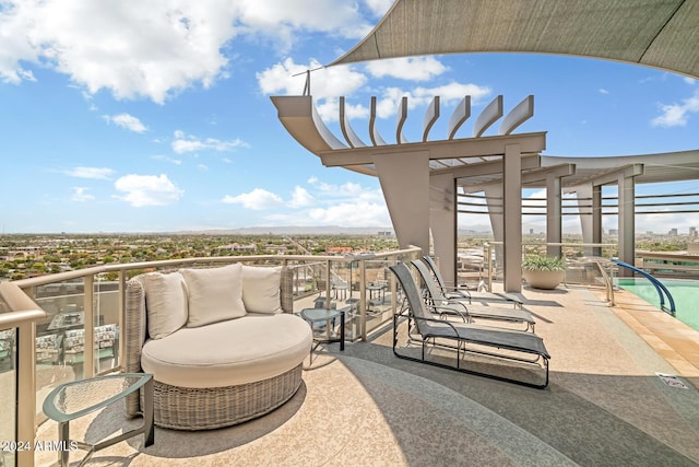 view of patio with an outdoor pool and a balcony