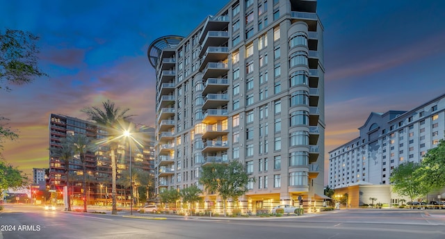 property at dusk featuring a city view