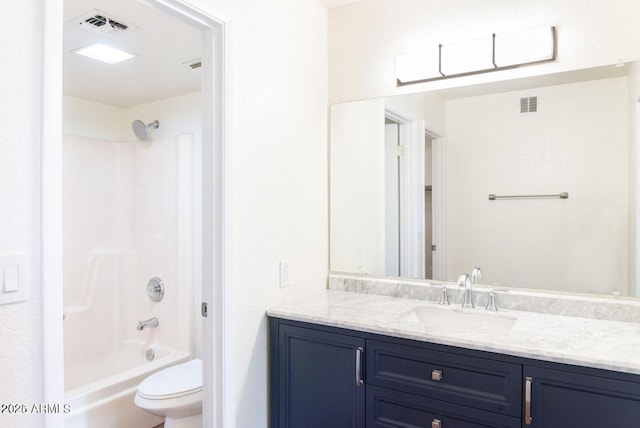bathroom featuring toilet, vanity, visible vents, and shower / bathing tub combination