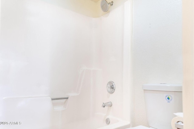 bathroom featuring toilet and shower / bathtub combination