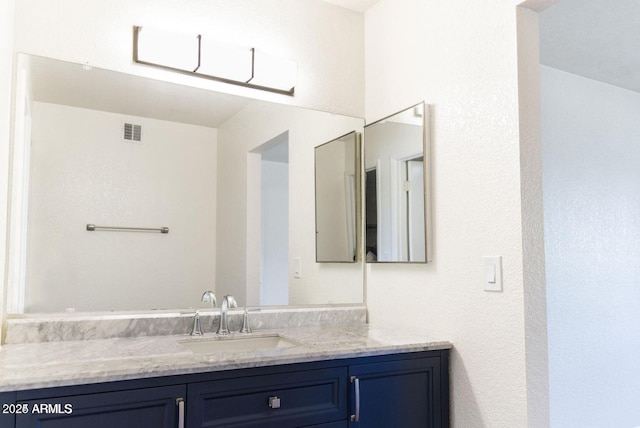bathroom featuring vanity and visible vents
