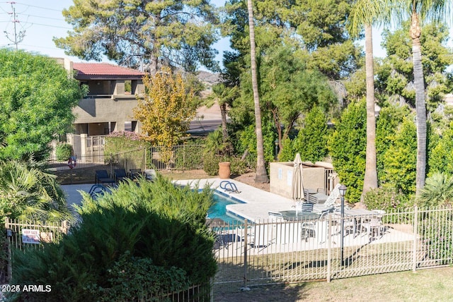 pool featuring a patio area and fence