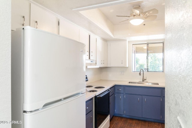 kitchen with a sink, freestanding refrigerator, electric range oven, under cabinet range hood, and blue cabinets