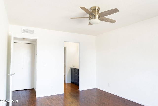 unfurnished bedroom featuring dark wood-style flooring, ceiling fan, and visible vents