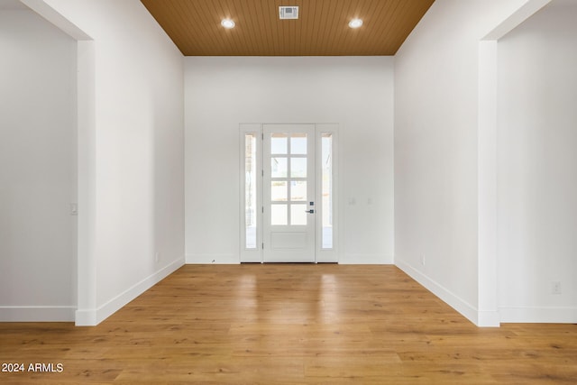 entrance foyer with wood ceiling and light hardwood / wood-style flooring