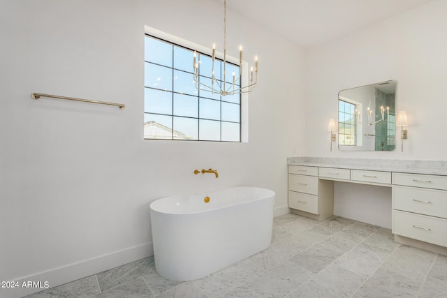 bathroom featuring vanity, a tub, and a chandelier