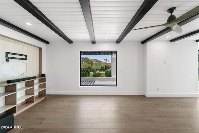 unfurnished room featuring beam ceiling, wood-type flooring, and ceiling fan