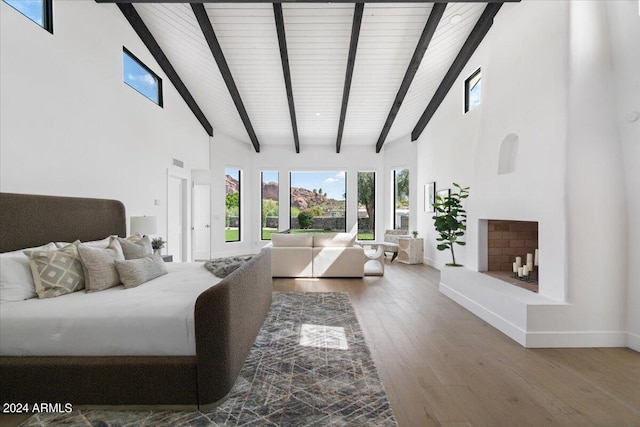 interior space with high vaulted ceiling, hardwood / wood-style flooring, and beam ceiling