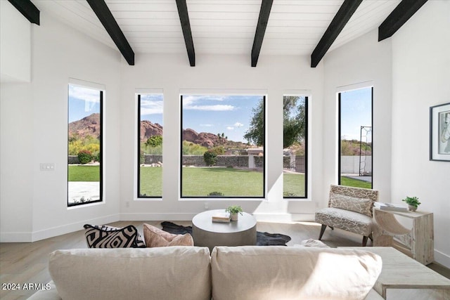 living room featuring beam ceiling and hardwood / wood-style floors