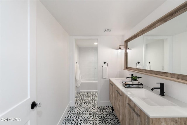 bathroom with tile floors, bathtub / shower combination, and double sink vanity