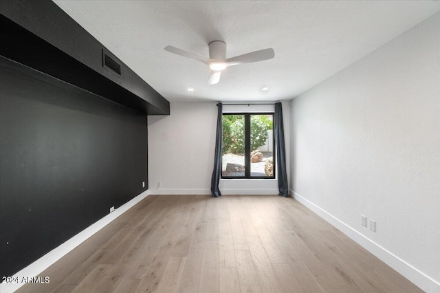 unfurnished room featuring ceiling fan and light hardwood / wood-style floors