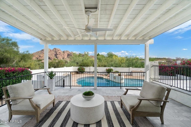 view of patio / terrace featuring ceiling fan and a fenced in pool