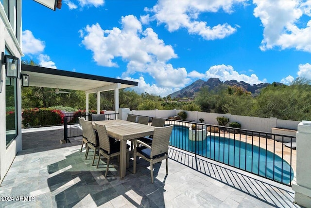 view of terrace featuring a mountain view and a fenced in pool