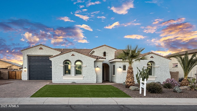 mediterranean / spanish-style home featuring a garage