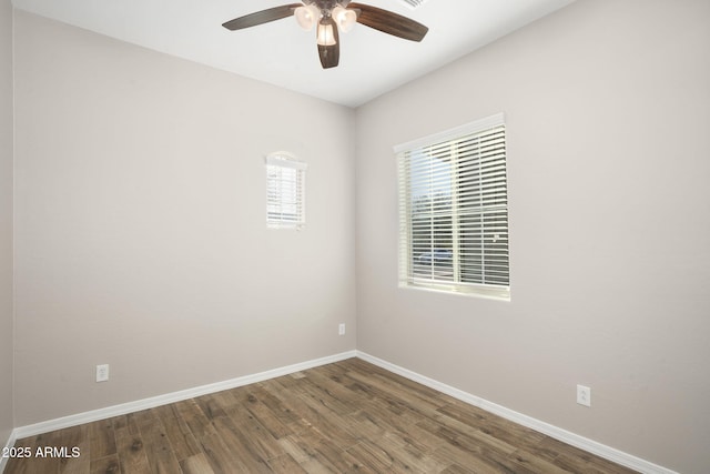 empty room featuring ceiling fan and dark hardwood / wood-style floors