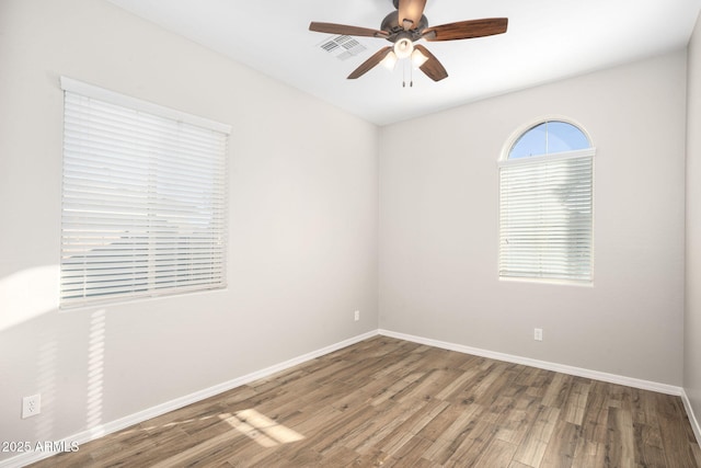 empty room with ceiling fan and wood-type flooring