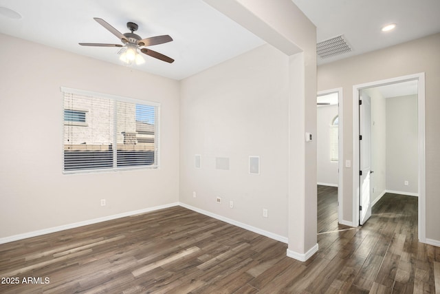 unfurnished room with ceiling fan and dark wood-type flooring