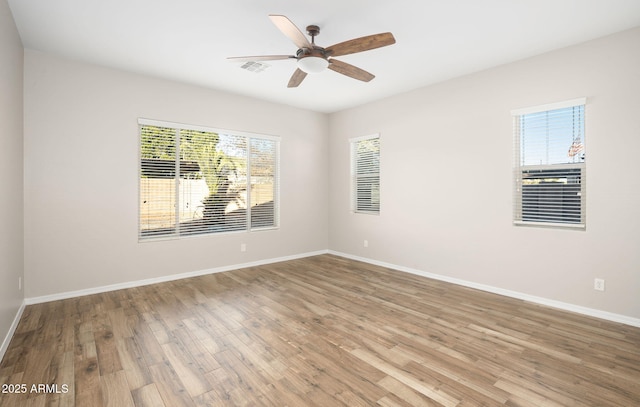 spare room with ceiling fan and hardwood / wood-style flooring