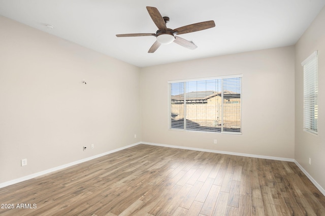 unfurnished room with ceiling fan and hardwood / wood-style flooring