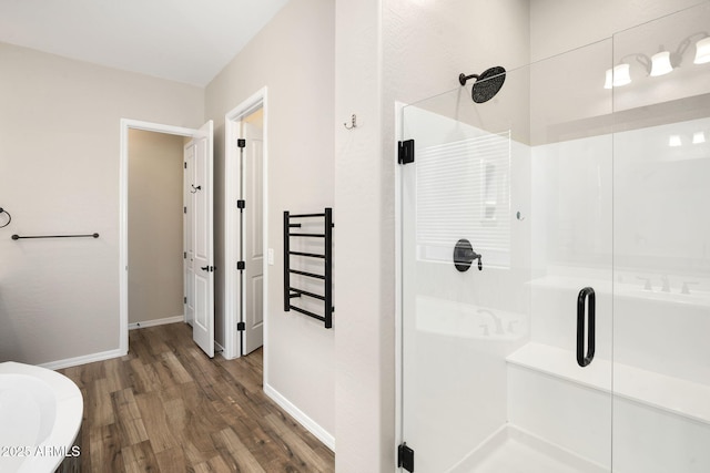 bathroom with an enclosed shower and hardwood / wood-style flooring